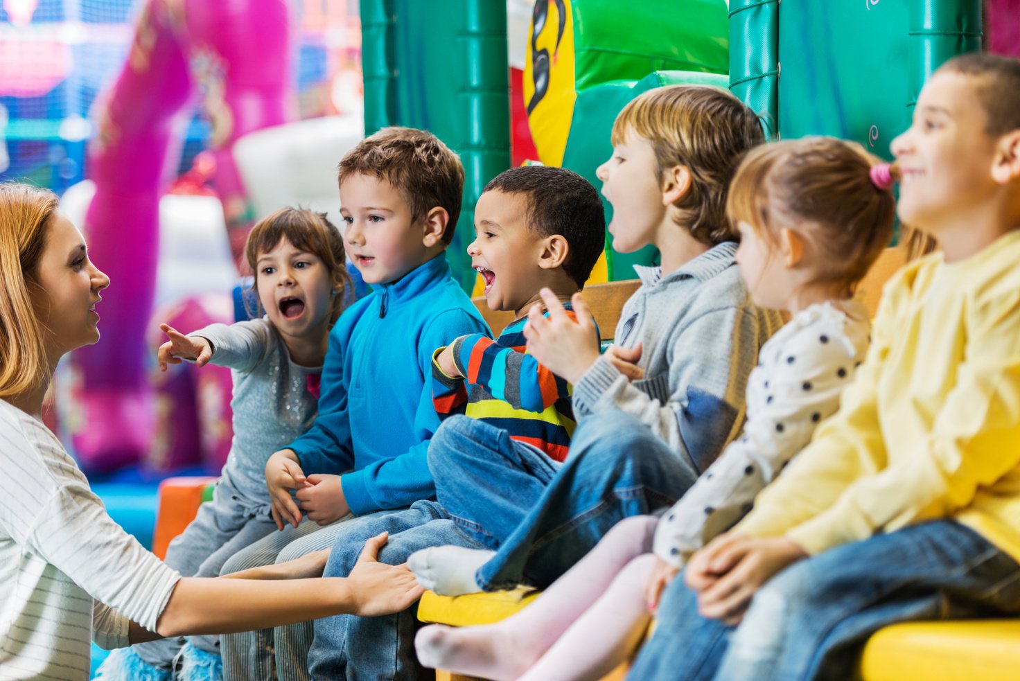 Children singing with their teacher.